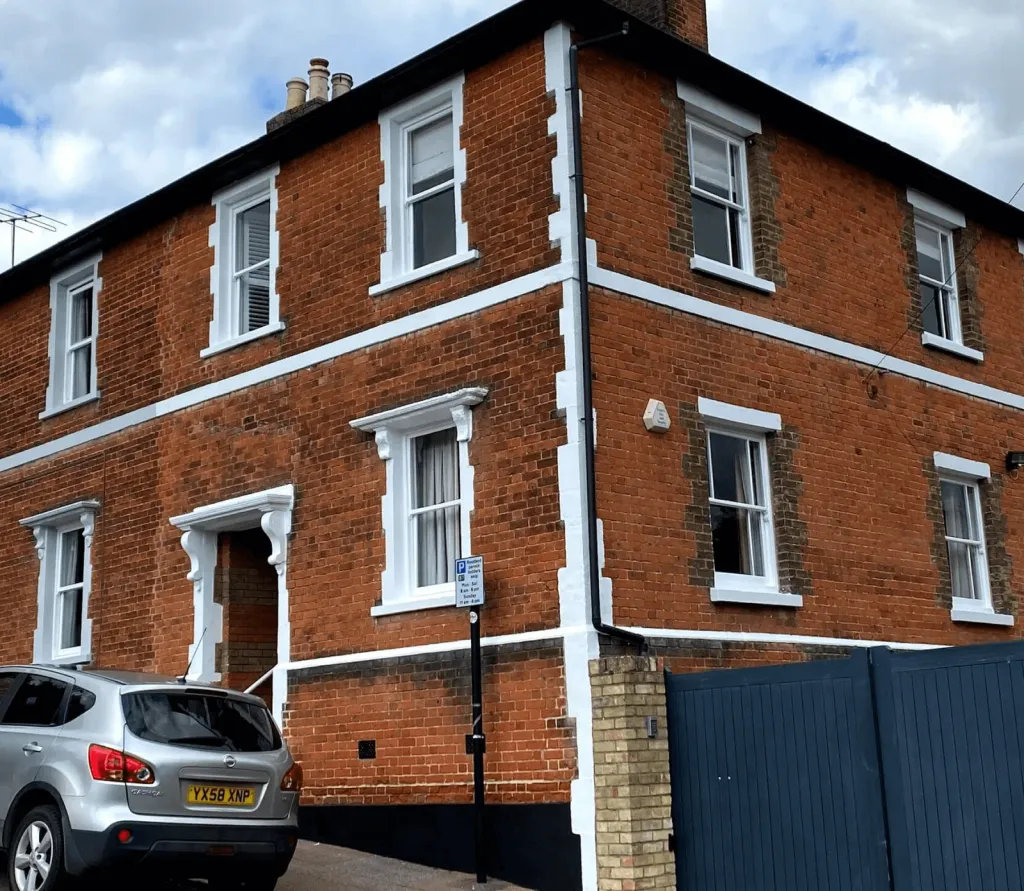 Restored timber sash windows on a period brick house
