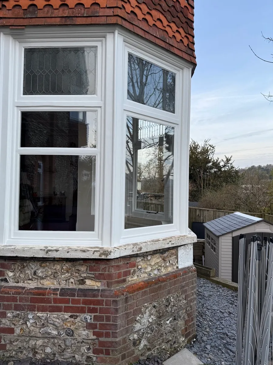 Restored timber sash window on a period brick house