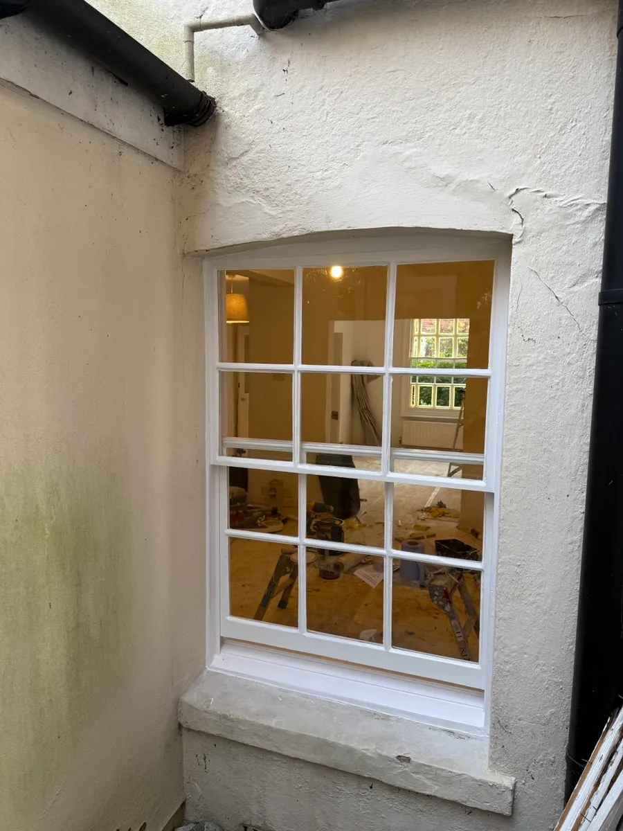 Restored timber sash window on a period brick house